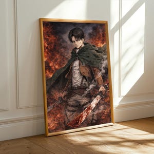 May include: Framed artwork depicting a character from the anime series Attack on Titan. The character is shown with a determined expression, holding two swords, against a fiery backdrop. The artwork is in a wooden frame.