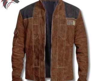May include: Brown suede jacket with black shoulder accents, a zip-up front, and multiple pockets. The jacket features a dark interior lining and a small patch on the upper arm. The jacket has a classic design.