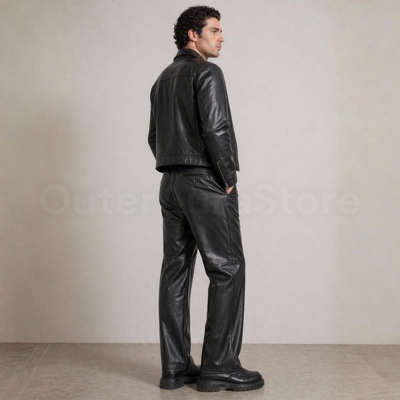 May include: A black leather jacket and matching pants. The jacket has a classic collar and a straight hem. The pants are straight-legged and have a relaxed fit. The outfit is worn with black boots. The text "Outer Store" is visible in the background.