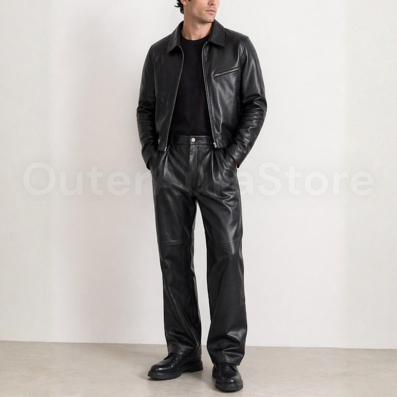 May include: A black leather jacket with a collared neckline and a zipper closure, paired with matching black leather pants. The outfit is completed with black shoes. The overall style is sleek and modern.