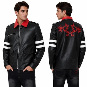 May include: A black jacket featuring a red collar, a silver front zip, and two white horizontal stripes on each sleeve. The back displays a red embroidered graphic design. The jacket includes shoulder epaulets and two front flap pockets.