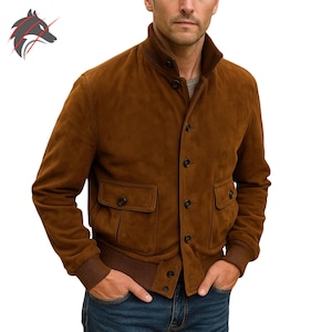 May include: A brown suede bomber jacket with a button-up front, two front pockets, and a ribbed hem and cuffs. The jacket has a stand-up collar and is a medium brown colour. The jacket is a classic style.