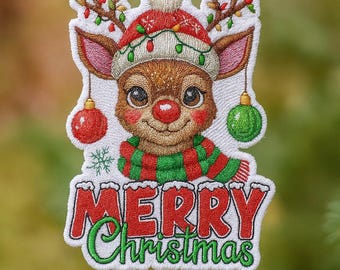 May include: Embroidered Christmas ornament featuring a reindeer wearing a red and green hat and scarf. The reindeer has a red nose and is adorned with Christmas lights. The ornament has the words "MERRY Christmas" in red and green.