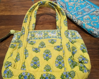 Two Vera Bradley quilted cloth bags. One is a wristlet. Beautiful condition. Totally clean inside and out. Enjoy her quality.