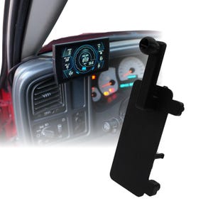 May include: A black digital gauge display mounted in a vehicle's dashboard. The screen shows blue and white readouts for engine performance. A black mounting bracket is also visible.