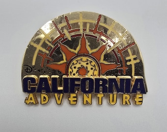 Vintage official Disney pin that says "Disney's California Adventure" with the image of a sun behind it