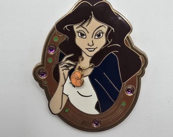 Vintage official Disney pin that shows Ursula from The Little Mermaid in her human disguise, Vanessa, holding a dangling seashell