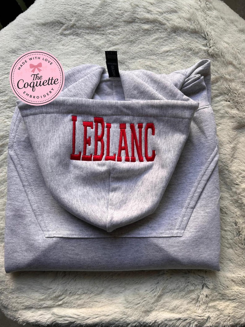 May include: A set of three ceramic mugs with a speckled, matte finish. The mugs are in shades of cream, light gray, and dark gray. Each mug has a simple, minimalist design, perfect for coffee or tea.