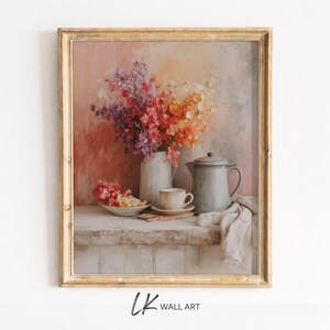 May include: A framed wall art print featuring a still life painting of a white pitcher filled with colorful purple, pink, and orange flowers, a small bowl of petals, a teacup on a saucer, and a grey teapot, all set on a wooden surface.