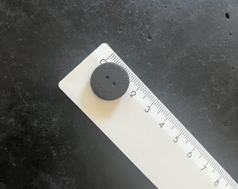 One Vintage CHANEL black matte buttons featured on Circa 1990's