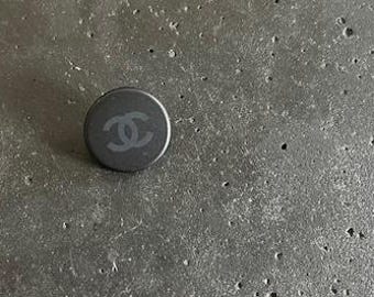 One Vintage CHANEL black matte resin button with CC's featured on Circa 1990's