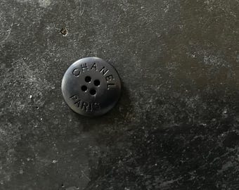 One Vintage CHANEL black resin buttons featured on Circa 1990's