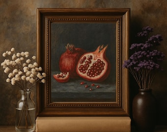 May include: A framed still life painting of pomegranates. The painting depicts two whole pomegranates and one cut open, revealing the red seeds. The frame is brown, and the painting is set on a table with flowers in vases.