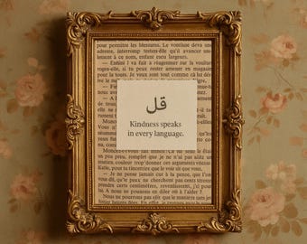 May include: A vintage gold ornate picture frame with a printed message that reads "Kindness speaks in every language." The frame is set against a floral wallpaper background.