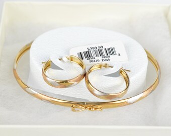 May include: A tri-color gold bangle bracelet and a pair of matching hoop earrings featuring alternating bands of yellow, white, and rose gold. The jewelry set includes a white tag with the text $399.99, 48352, 52302, 50210, and D/44.