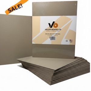 May include: A stack of Pichel M Kraft Boards from Valor Board Co. The boards are a light brown color and are packaged together. The packaging includes the company logo and product information. An orange "SALE!" banner is in the upper left corner.