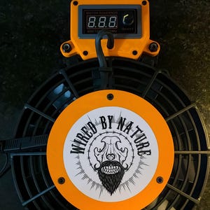May include: An orange and black electric fan with a digital display and the words "MOTOR GOVERNOR". The fan has a circular design with the words "WIRED BY NATURE" surrounding a skull and beard graphic.