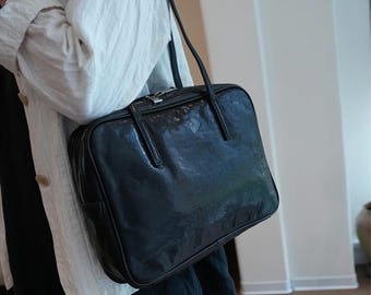 Bolsa de ombro artesanal em couro estilo vintage: tamanho grande, alça de couro, pasta preta delicada.