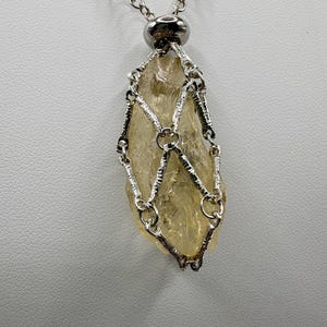 Steel Cage for a Wild Sunstone – Plush Oregon Raw Crystal Pendant