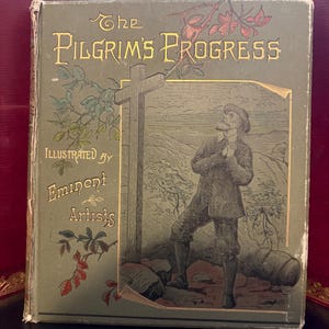 May include: Antique book titled "The Pilgrim's Progress" with gold lettering and illustrations. The cover is a faded green with an illustration of a man and a cross. The text "Illustrated by Eminent Artists" is also visible.