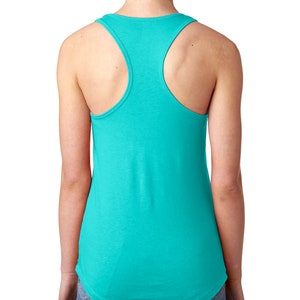 May include: A turquoise racerback tank top. The tank top has a rounded neckline and a curved hemline. The back features a racerback design with wide straps. The fabric appears soft and lightweight, suitable for warm weather.