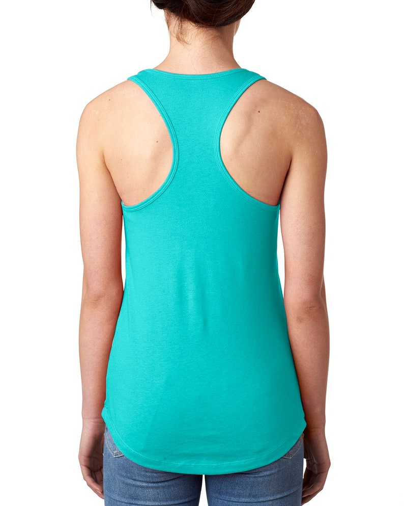 May include: A turquoise racerback tank top. The tank top has a rounded neckline and a curved hemline. The back features a racerback design with wide straps. The fabric appears soft and lightweight, suitable for warm weather.