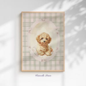 May include: A framed print featuring a charming illustration of a fluffy, light brown poodle puppy. The puppy is seated inside a soft pink oval with paw prints, set against a light green and white plaid background. The text "Wisterelle Prints" is at the bottom.