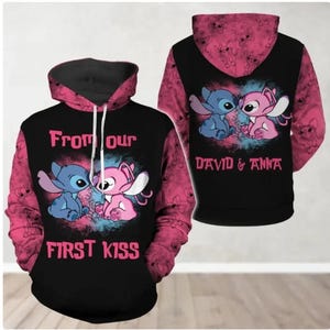 May include: Black hoodie with a pink and black design featuring cartoon characters. The front of the hoodie says "From our first kiss" with the characters. The back says "David & Anna". The sleeves are pink with a repeating character pattern.