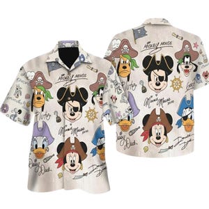 May include: A short-sleeved shirt with a pirate theme, featuring Mickey Mouse, Minnie Mouse, Pluto, and Donald Duck. The off-white shirt has pirate illustrations and character names. The shirt is a casual wear item.