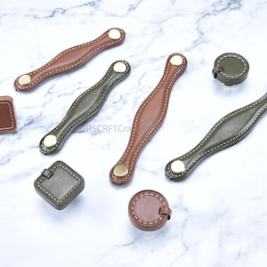 May include: A set of three ceramic mugs with a speckled, matte finish. The mugs are in shades of cream, light gray, and dark gray. Each mug has a simple, minimalist design, perfect for coffee or tea.