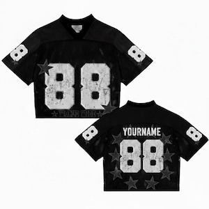 May include: Black cropped football jersey with white distressed numbers "88" and star accents. The jersey has a v-neck and mesh fabric. The back of the jersey has the text "YOURNAME" above the number "88". The text "WORLD WIDE" is below the number "88".
