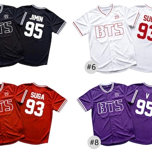 May include: Four short-sleeve button-down baseball jerseys in black, white, red, and purple. Each jersey features the text BTS on the front and a name with a number on the back, including JIMIN 95, SUGA 93, and V 95, with striped collar and sleeve trim.
