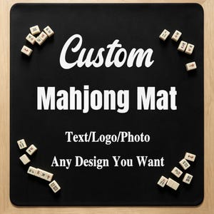 May include: A black rectangular mahjong mat featuring white text that reads Custom Mahjong Mat, Text/Logo/Photo, and Any Design You Want. Several small white mahjong tiles with black and red markings are scattered around the edges of the mat.