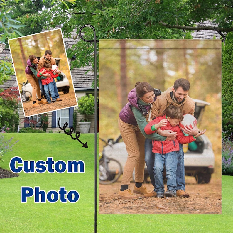 May include: A garden flag featuring a family portrait. The image shows a family of three, with a child holding a ball. The flag has the words "Custom Photo" in blue and white.