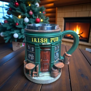 May include: A green ceramic mug with an Irish pub design. The mug features the words "IRISH PUB EST.1999" and a detailed facade with a door, windows, and small tables. The handle is green and the rim is silver.