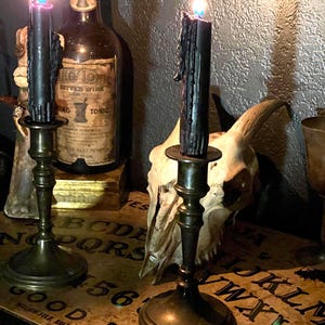 Antique Brass Candle Stands with Pair of Black Spell Candles