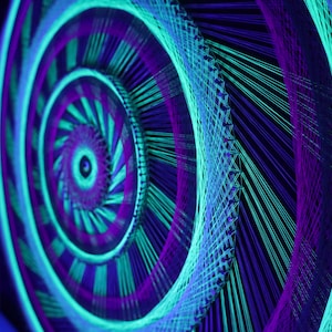 May include: A spiral string art piece in neon green, purple, and blue. The artwork has a concentric design, with the colours radiating from the centre. The piece is set against a dark background.