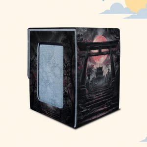 May include: A square storage box featuring a dark, atmospheric graphic print of a traditional torii gate, stone steps, and a large red moon. The side panel includes a rectangular light gray fabric insert, while the overall design is black and red.