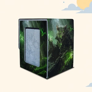 May include: A rectangular deck box featuring a dark green and black graphic print of a rat character with glowing green eyes and magical energy. The box has a solid grey rectangular panel on the front side and a textured, fabric-like exterior finish.