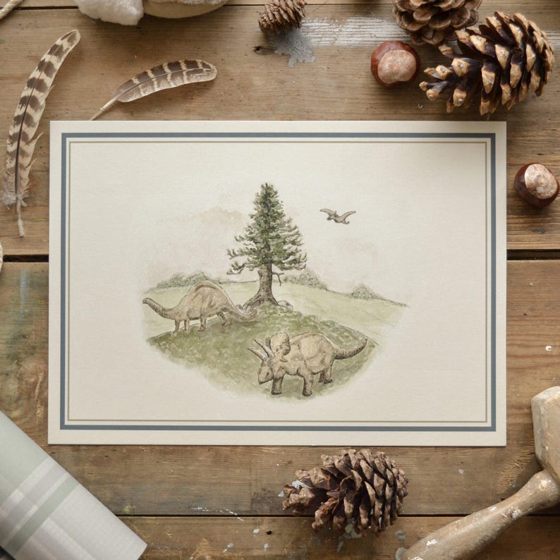 May include: A framed watercolor print featuring a prehistoric scene with two dinosaurs, a tree, and a flying pterodactyl. The artwork has a light green and beige color palette, with a blue border. The print is displayed on a rustic wooden surface.