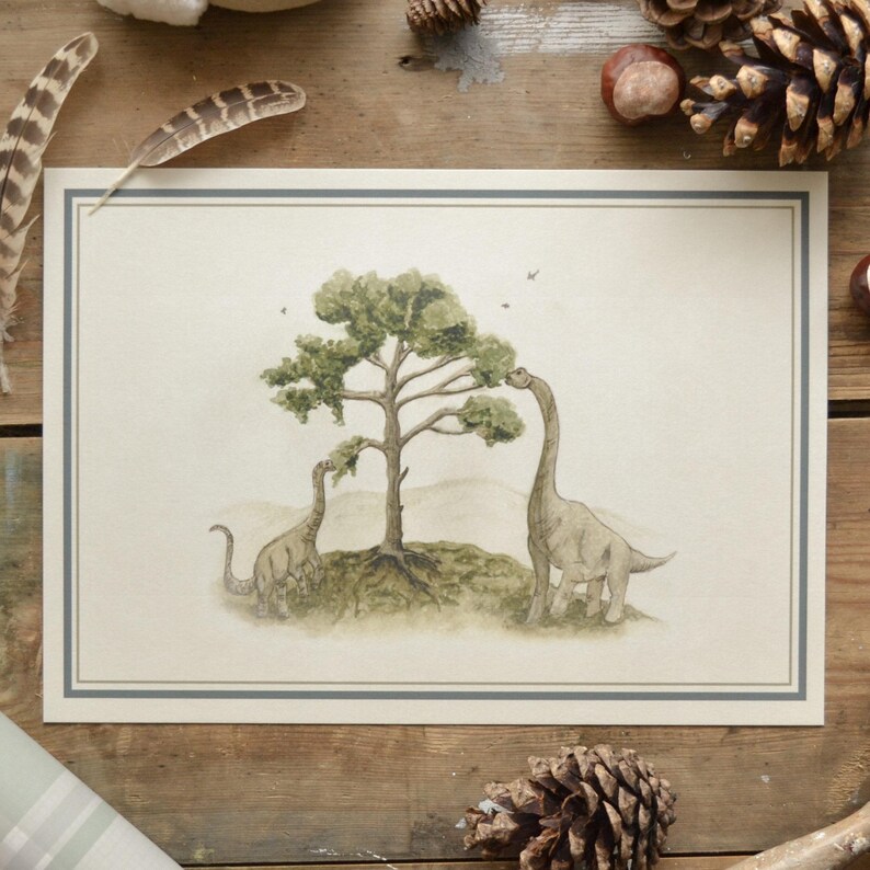 May include: Watercolor illustration of two dinosaurs reaching for the leaves of a tree. The artwork is framed with a thin blue border on a cream background. The dinosaurs are a muted green color.