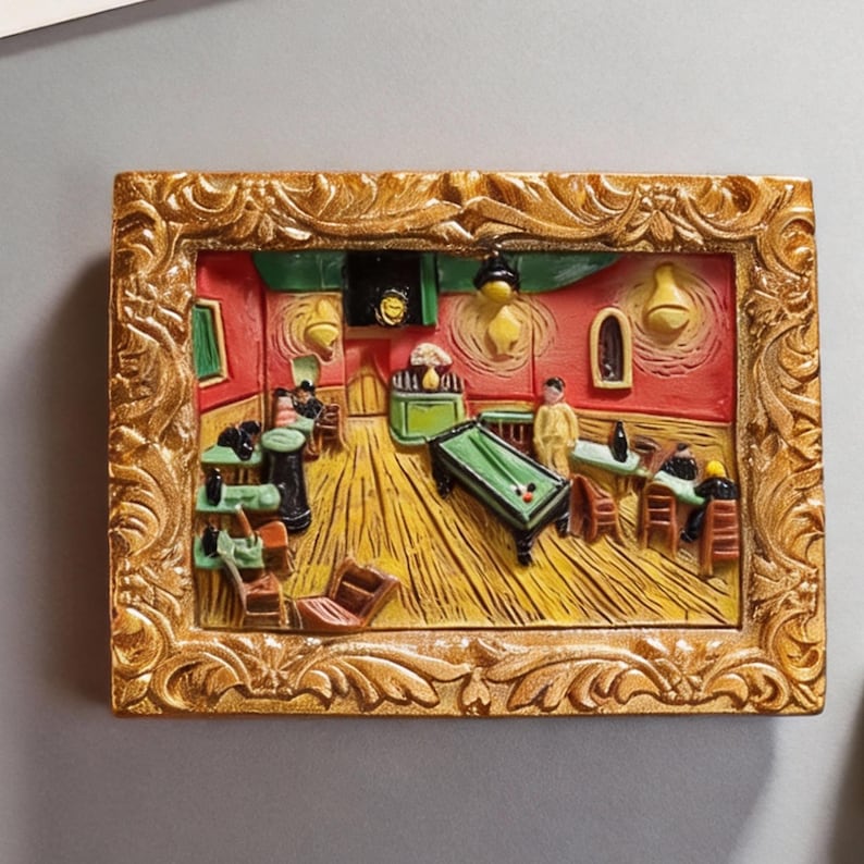 May include: A rectangular, gold-framed relief sculpture depicting Van Gogh's "The Night Cafe." The artwork features a yellow-lit interior with a pool table, figures, and a red and yellow color scheme. The frame has ornate, swirling details.
