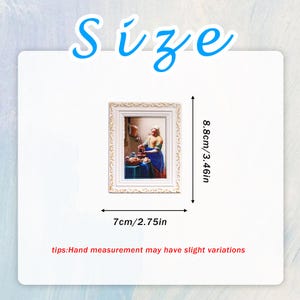 May include: A small, rectangular white framed print of a painting. The painting depicts a woman in a kitchen. The frame is 2.75 inches wide and 3.46 inches tall. The word "Size" is written in blue cursive at the top.