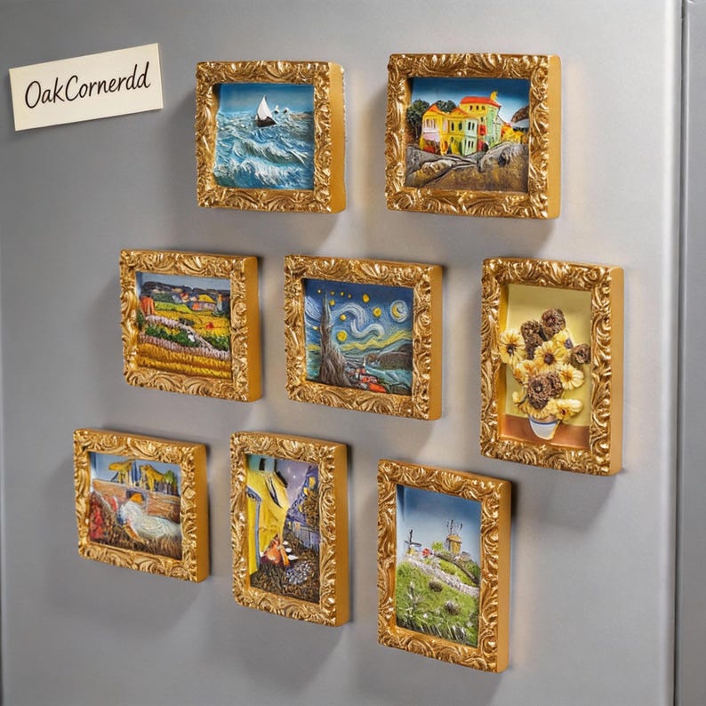 May include: A collection of framed art magnets with gold-colored ornate frames. The miniature artworks depict various scenes, including a seascape, a village, sunflowers, and a starry night. The magnets are displayed on a silver surface.