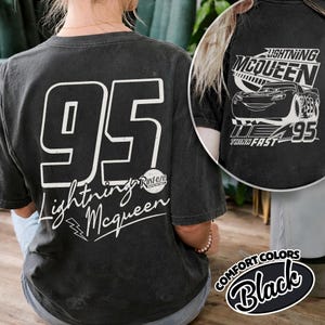 May include: Black t-shirt with the number "95" and "Lightning McQueen" in white. The shirt also features a Lightning McQueen graphic and the words "Think Fast". Part of the Comfort Colors range.