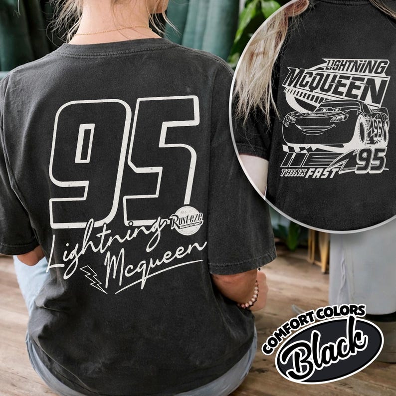 May include: Black t-shirt with the number "95" and "Lightning McQueen" in white. The shirt also features a Lightning McQueen graphic and the words "Think Fast". Part of the Comfort Colors range.
