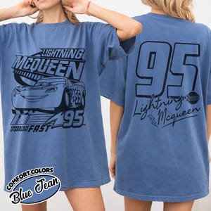 May include: Blue jean t-shirt with a Lightning McQueen design. The front features the character's name and image, plus the number 95. The back of the shirt has a large number 95 and the Lightning McQueen logo. The shirt is a comfortable fit.