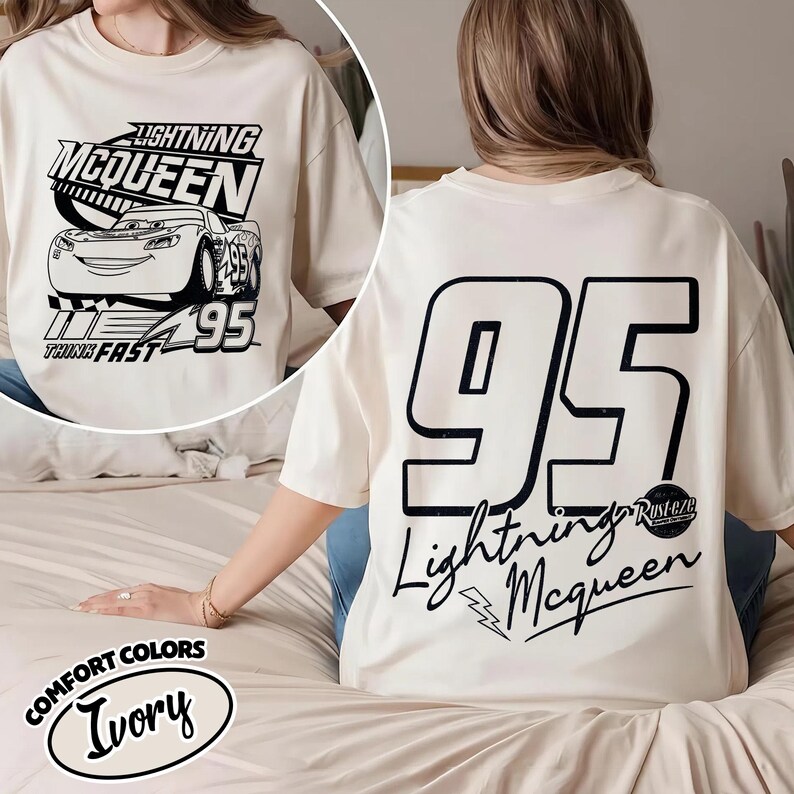 May include: Ivory t-shirt with Lightning McQueen design. The front has a black and white image of the car, the text "Lightning McQueen" and "Think Fast". The back features a large "95" and "Lightning McQueen" in black.