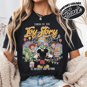 May include: A white ceramic mug with a black handle and the text "But First, Coffee" in a handwritten style. The mug is on a white surface. The mug is approximately 10 cm tall.