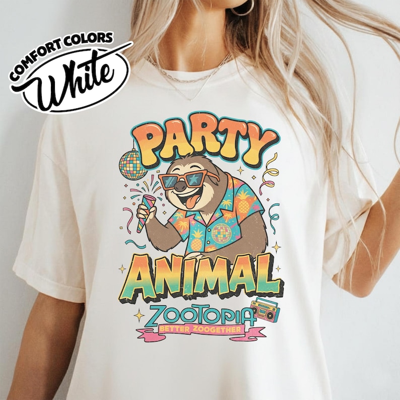 May include: White Comfort Colors t-shirt with a colorful graphic. The graphic features a cartoon sloth wearing sunglasses and a Hawaiian shirt, holding a microphone. The text reads "PARTY ANIMAL ZOOTOPIA BETTER ZOOGETHER".